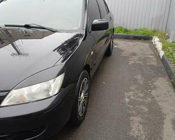 Черный Мицубиси Лансер, объемом двигателя 1.58 л и пробегом 180 тыс. км за 4500 $, фото 2 на Automoto.ua