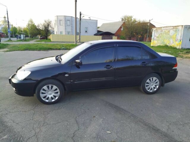 Черный Мицубиси Лансер, объемом двигателя 1.6 л и пробегом 32 тыс. км за 9000 $, фото 3 на Automoto.ua