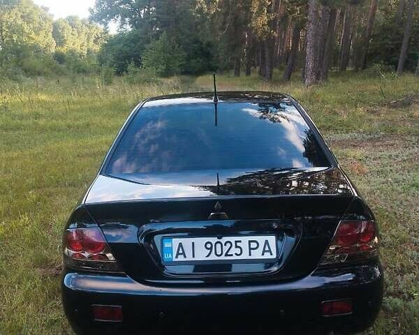 Черный Мицубиси Лансер, объемом двигателя 1.6 л и пробегом 270 тыс. км за 5200 $, фото 7 на Automoto.ua