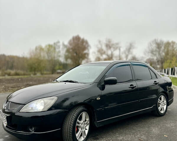 Черный Мицубиси Лансер, объемом двигателя 2 л и пробегом 260 тыс. км за 5300 $, фото 6 на Automoto.ua