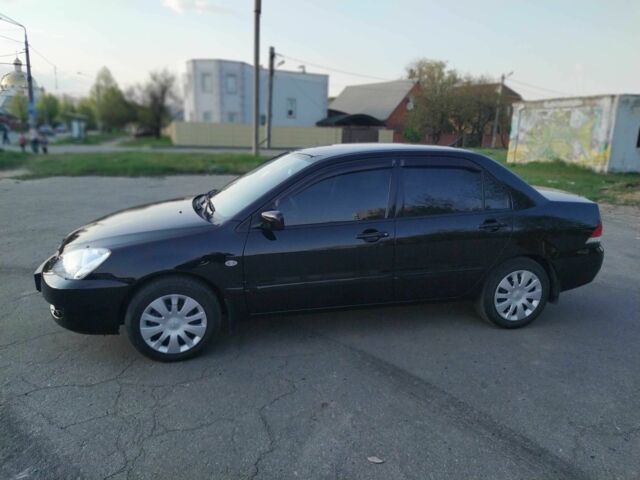 Черный Мицубиси Лансер, объемом двигателя 1.6 л и пробегом 32 тыс. км за 9000 $, фото 1 на Automoto.ua