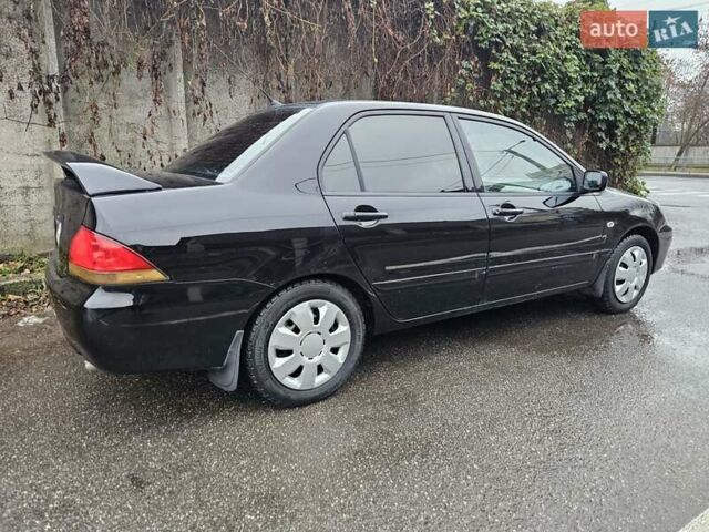 Черный Мицубиси Лансер, объемом двигателя 1.6 л и пробегом 152 тыс. км за 4999 $, фото 1 на Automoto.ua