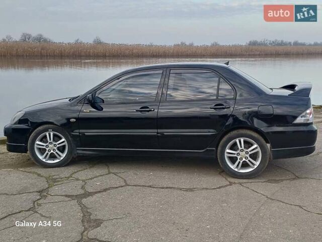 Черный Мицубиси Лансер, объемом двигателя 2 л и пробегом 286 тыс. км за 4000 $, фото 3 на Automoto.ua