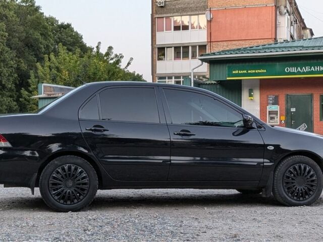 Черный Мицубиси Лансер, объемом двигателя 1.6 л и пробегом 226 тыс. км за 4800 $, фото 12 на Automoto.ua