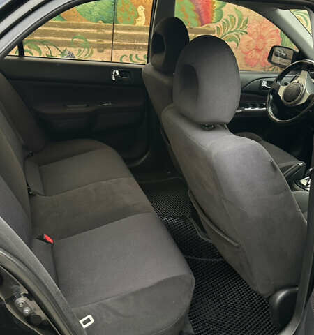 Черный Мицубиси Лансер, объемом двигателя 2 л и пробегом 143 тыс. км за 4999 $, фото 4 на Automoto.ua