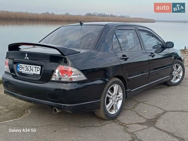 Черный Мицубиси Лансер, объемом двигателя 2 л и пробегом 286 тыс. км за 4000 $, фото 6 на Automoto.ua