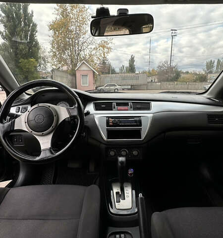 Черный Мицубиси Лансер, объемом двигателя 2 л и пробегом 143 тыс. км за 4999 $, фото 8 на Automoto.ua