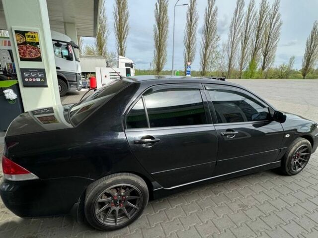 Черный Мицубиси Лансер, объемом двигателя 1.6 л и пробегом 211 тыс. км за 5600 $, фото 7 на Automoto.ua