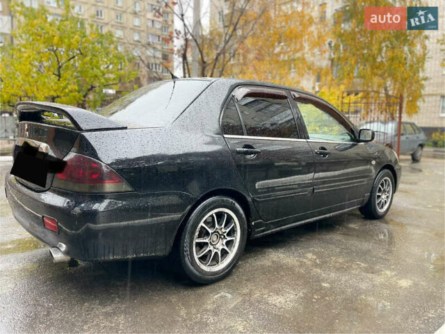 Черный Мицубиси Лансер, объемом двигателя 1.58 л и пробегом 265 тыс. км за 3550 $, фото 2 на Automoto.ua