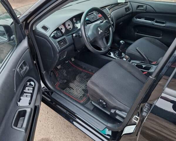 Чорний Міцубісі Lancer, об'ємом двигуна 1.6 л та пробігом 273 тис. км за 3999 $, фото 28 на Automoto.ua