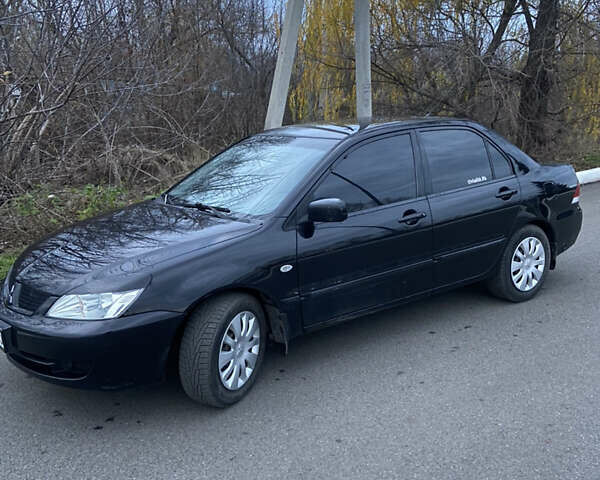 Черный Мицубиси Лансер, объемом двигателя 1.58 л и пробегом 213 тыс. км за 4900 $, фото 1 на Automoto.ua