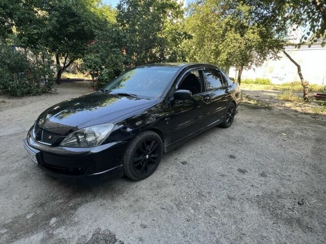 Черный Мицубиси Лансер, объемом двигателя 2 л и пробегом 240 тыс. км за 5600 $, фото 5 на Automoto.ua