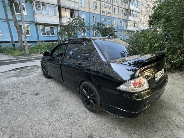 Черный Мицубиси Лансер, объемом двигателя 2 л и пробегом 240 тыс. км за 5600 $, фото 4 на Automoto.ua