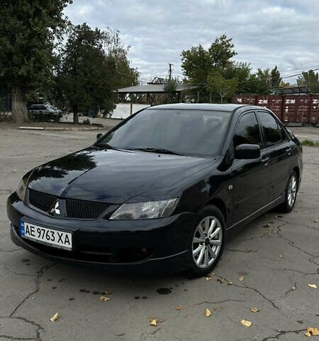 Черный Мицубиси Лансер, объемом двигателя 2 л и пробегом 143 тыс. км за 4999 $, фото 1 на Automoto.ua