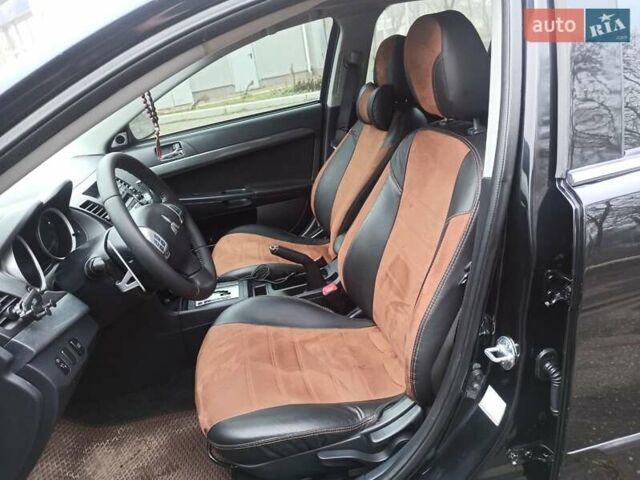 Черный Мицубиси Лансер, объемом двигателя 2 л и пробегом 195 тыс. км за 7899 $, фото 9 на Automoto.ua