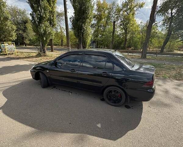 Черный Мицубиси Лансер, объемом двигателя 1.6 л и пробегом 244 тыс. км за 4100 $, фото 5 на Automoto.ua