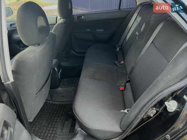 Чорний Міцубісі Lancer, об'ємом двигуна 1.58 л та пробігом 185 тис. км за 3750 $, фото 13 на Automoto.ua