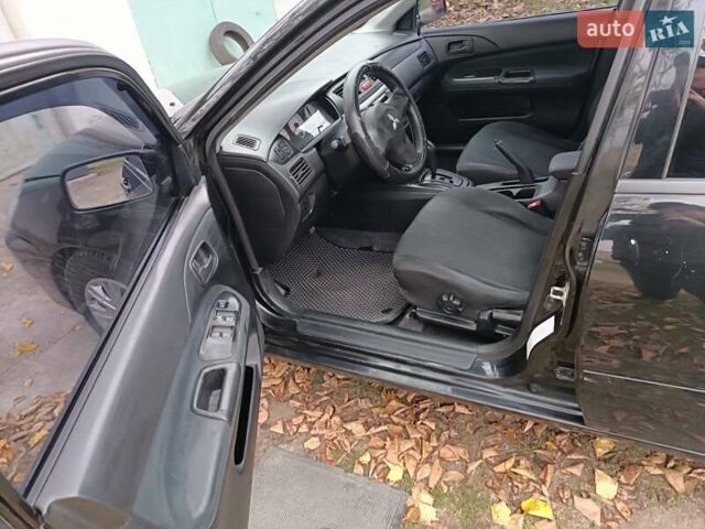 Чорний Міцубісі Lancer, об'ємом двигуна 1.58 л та пробігом 227 тис. км за 4100 $, фото 10 на Automoto.ua