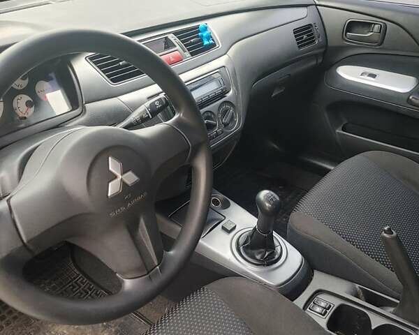 Чорний Міцубісі Lancer, об'ємом двигуна 1.58 л та пробігом 190 тис. км за 3750 $, фото 13 на Automoto.ua