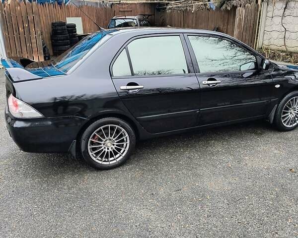 Черный Мицубиси Лансер, объемом двигателя 1.6 л и пробегом 309 тыс. км за 4000 $, фото 4 на Automoto.ua