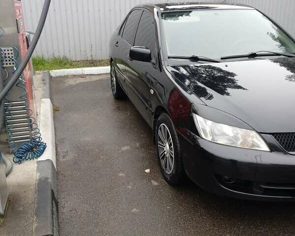 Черный Мицубиси Лансер, объемом двигателя 1.58 л и пробегом 180 тыс. км за 4500 $, фото 5 на Automoto.ua