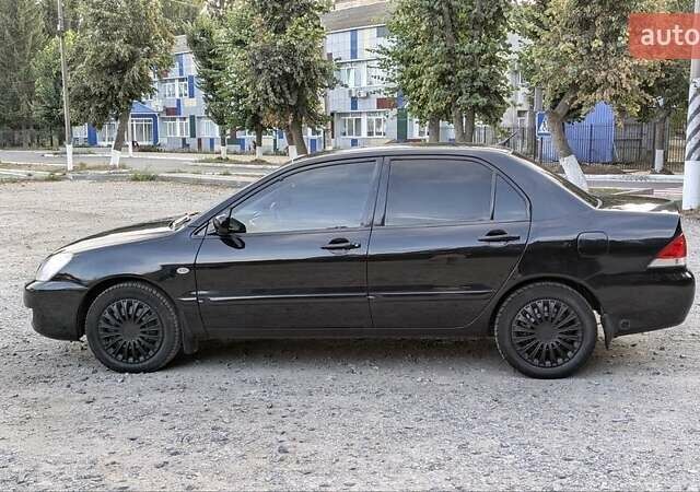 Черный Мицубиси Лансер, объемом двигателя 1.6 л и пробегом 226 тыс. км за 4800 $, фото 4 на Automoto.ua