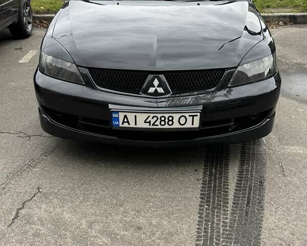 Черный Мицубиси Лансер, объемом двигателя 2 л и пробегом 219 тыс. км за 4400 $, фото 11 на Automoto.ua