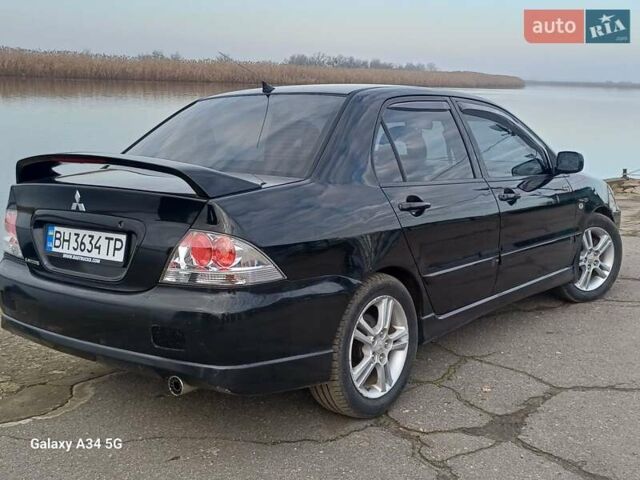 Черный Мицубиси Лансер, объемом двигателя 2 л и пробегом 286 тыс. км за 4000 $, фото 5 на Automoto.ua