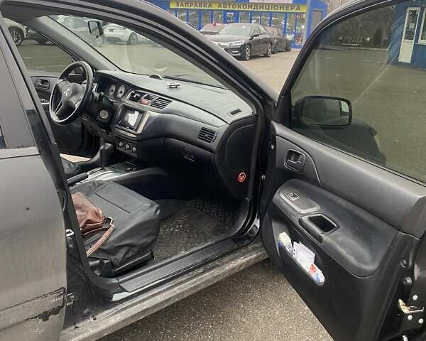 Черный Мицубиси Лансер, объемом двигателя 1.58 л и пробегом 263 тыс. км за 4000 $, фото 31 на Automoto.ua