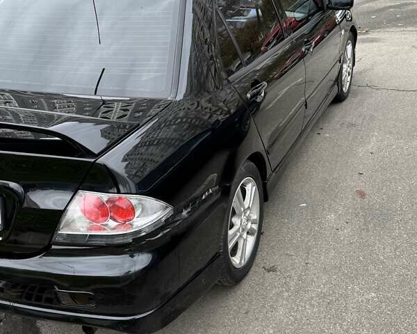 Черный Мицубиси Лансер, объемом двигателя 2 л и пробегом 219 тыс. км за 4400 $, фото 12 на Automoto.ua