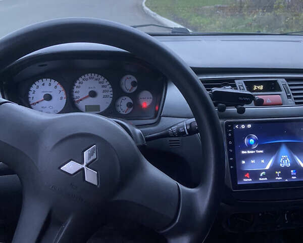 Черный Мицубиси Лансер, объемом двигателя 1.58 л и пробегом 213 тыс. км за 4900 $, фото 7 на Automoto.ua