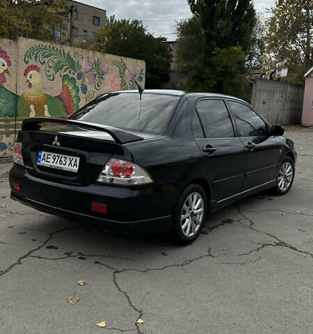 Черный Мицубиси Лансер, объемом двигателя 2 л и пробегом 143 тыс. км за 4999 $, фото 3 на Automoto.ua