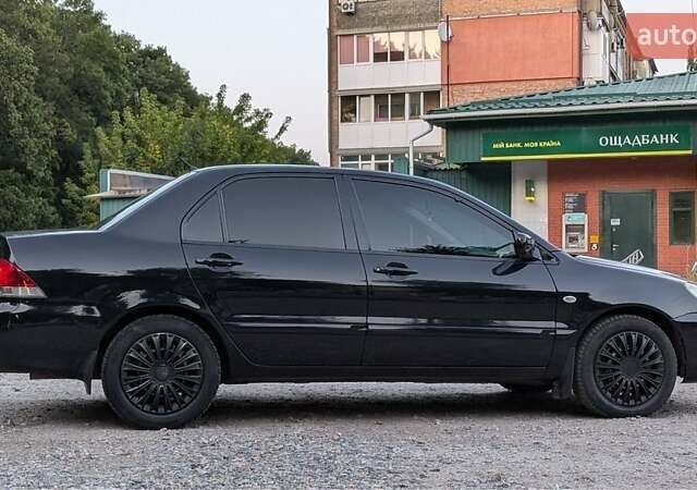 Черный Мицубиси Лансер, объемом двигателя 1.6 л и пробегом 226 тыс. км за 4800 $, фото 11 на Automoto.ua