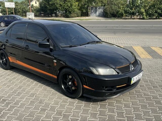 Черный Мицубиси Лансер, объемом двигателя 2 л и пробегом 224 тыс. км за 5800 $, фото 1 на Automoto.ua