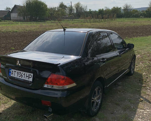 Черный Мицубиси Лансер, объемом двигателя 1.6 л и пробегом 145 тыс. км за 4999 $, фото 3 на Automoto.ua