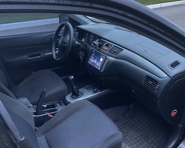 Черный Мицубиси Лансер, объемом двигателя 1.58 л и пробегом 213 тыс. км за 4900 $, фото 5 на Automoto.ua