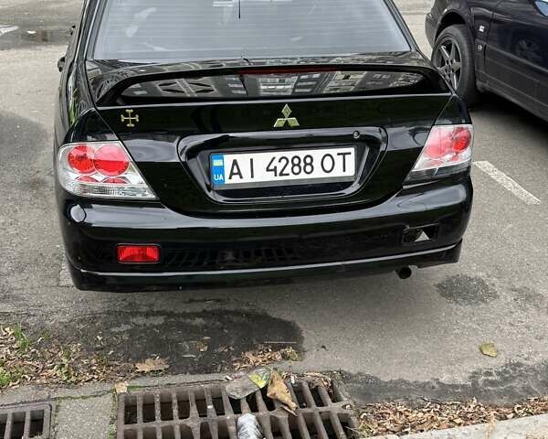 Черный Мицубиси Лансер, объемом двигателя 2 л и пробегом 219 тыс. км за 4400 $, фото 9 на Automoto.ua