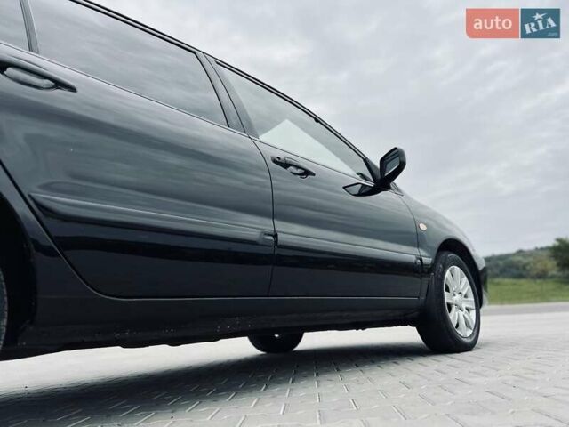 Чорний Міцубісі Lancer, об'ємом двигуна 1.6 л та пробігом 243 тис. км за 4950 $, фото 11 на Automoto.ua