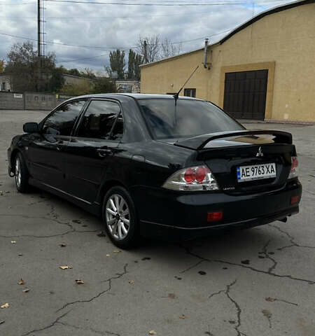 Черный Мицубиси Лансер, объемом двигателя 2 л и пробегом 143 тыс. км за 4999 $, фото 2 на Automoto.ua