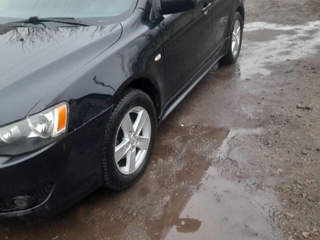 Черный Мицубиси Лансер, объемом двигателя 2 л и пробегом 215 тыс. км за 5700 $, фото 1 на Automoto.ua