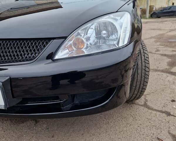 Чорний Міцубісі Lancer, об'ємом двигуна 1.6 л та пробігом 273 тис. км за 3999 $, фото 11 на Automoto.ua