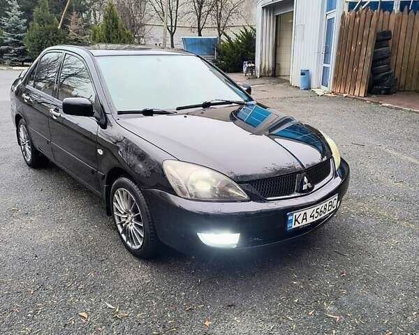 Черный Мицубиси Лансер, объемом двигателя 1.6 л и пробегом 309 тыс. км за 4000 $, фото 1 на Automoto.ua