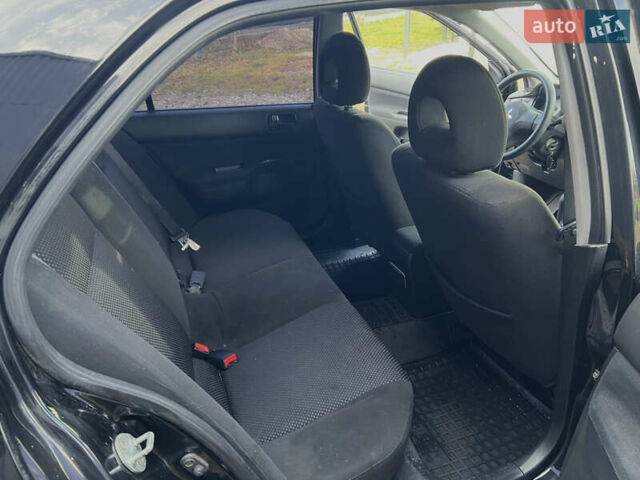 Чорний Міцубісі Lancer, об'ємом двигуна 1.58 л та пробігом 185 тис. км за 3750 $, фото 14 на Automoto.ua