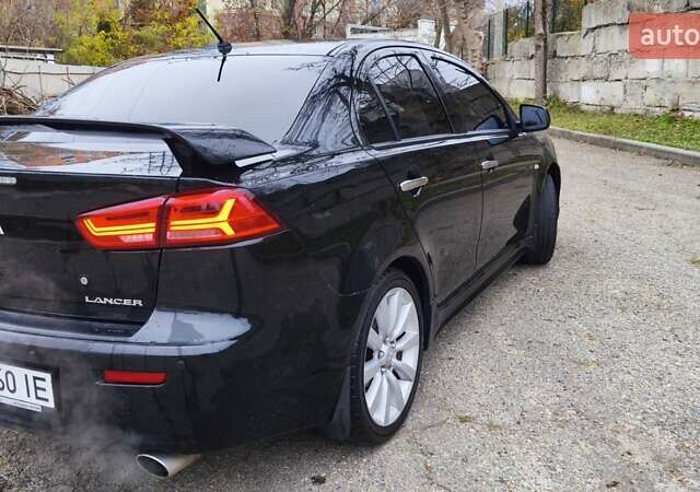Черный Мицубиси Лансер, объемом двигателя 2 л и пробегом 230 тыс. км за 7100 $, фото 4 на Automoto.ua