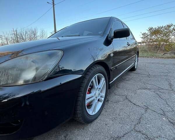 Черный Мицубиси Лансер, объемом двигателя 2 л и пробегом 280 тыс. км за 5400 $, фото 8 на Automoto.ua