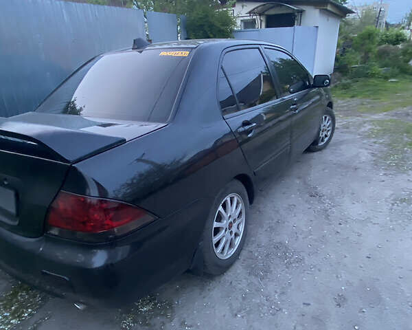 Чорний Міцубісі Lancer, об'ємом двигуна 1.6 л та пробігом 195 тис. км за 5200 $, фото 34 на Automoto.ua