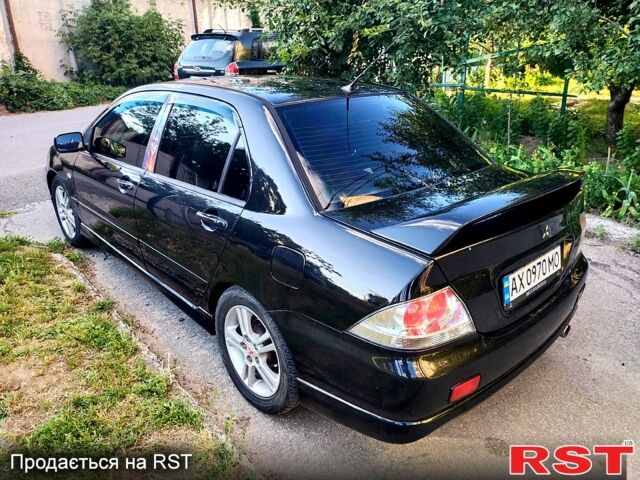 Черный Мицубиси Лансер, объемом двигателя 2 л и пробегом 200 тыс. км за 4450 $, фото 5 на Automoto.ua