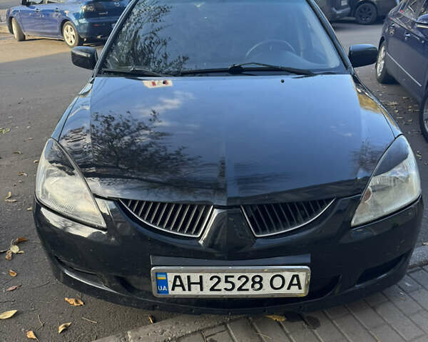 Чорний Міцубісі Lancer, об'ємом двигуна 1.58 л та пробігом 243 тис. км за 3800 $, фото 10 на Automoto.ua