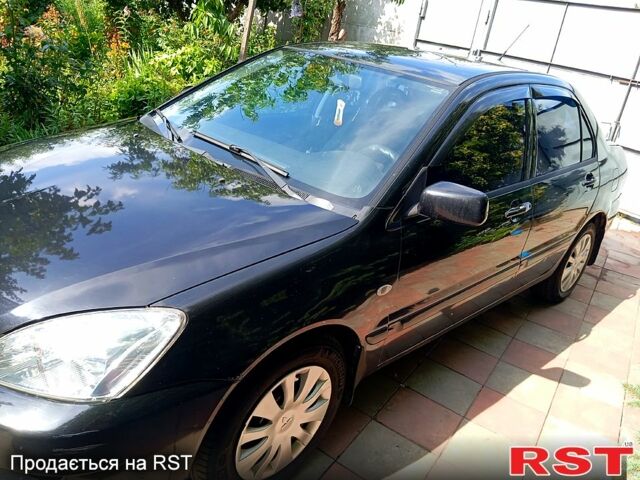 Черный Мицубиси Лансер, объемом двигателя 1.6 л и пробегом 247 тыс. км за 4000 $, фото 1 на Automoto.ua