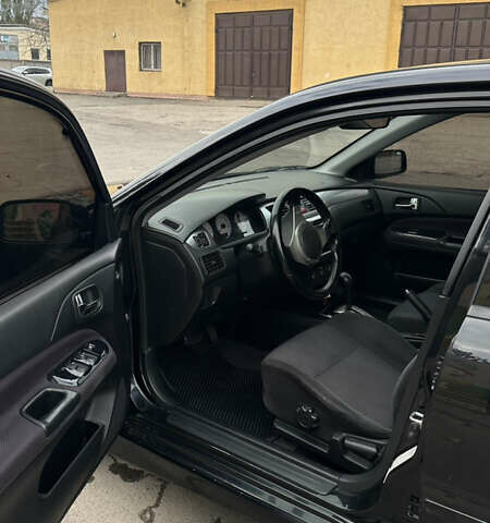 Черный Мицубиси Лансер, объемом двигателя 2 л и пробегом 143 тыс. км за 4999 $, фото 7 на Automoto.ua